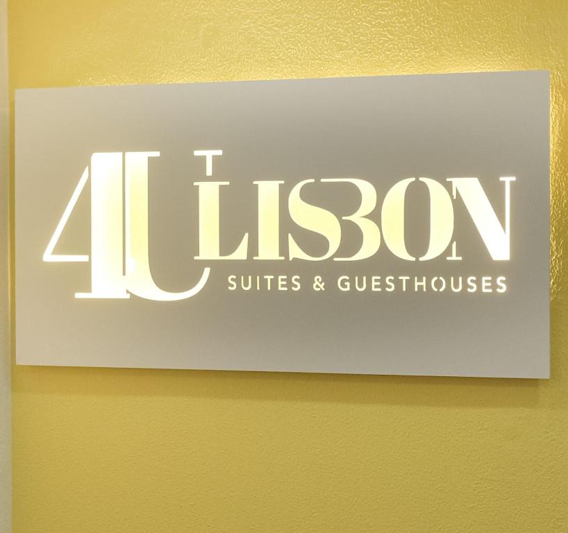 a sign for a litzon suites and guesthouses at 4U Lisbon Suites & Guesthouse VII Airport in Lisbon