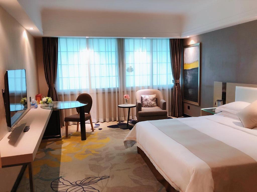 Postel nebo postele na pokoji v ubytování Shenzhen Kaili Hotel, Guomao Shopping Mall