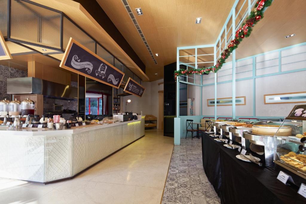 a restaurant with a bakery with a counter with pastries at Hotel 7 Taichung in Taichung