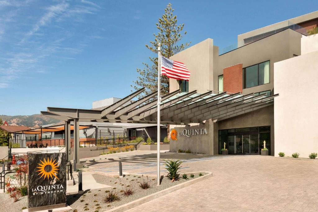 a building with an american flag in front of it at La Quinta by Wyndham San Luis Obispo in San Luis Obispo