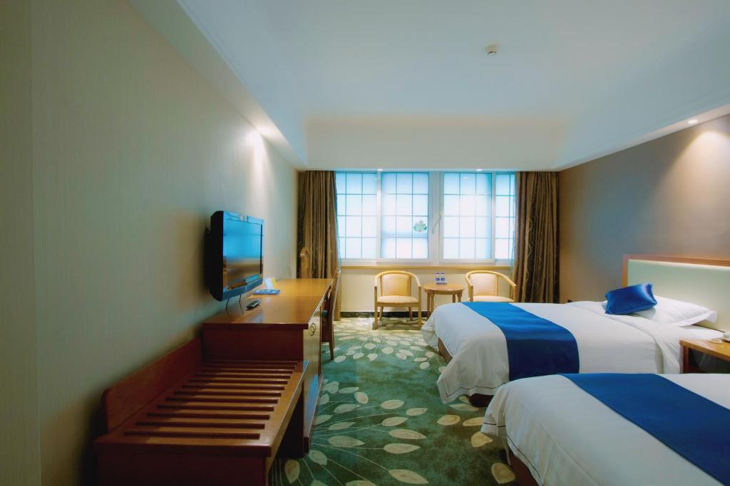 Postel nebo postele na pokoji v ubytování Shenzhen Kaili Hotel, Guomao Shopping Mall