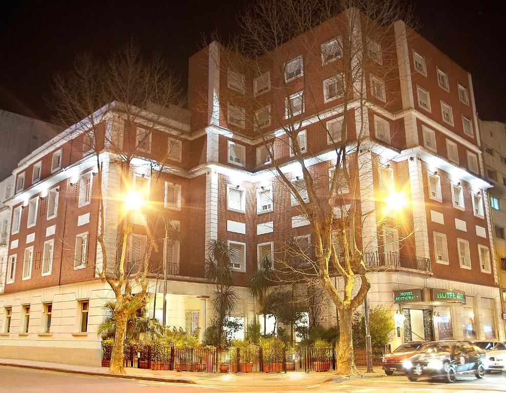 a large brick building with lights on it at night at Garden Hotel in Mar del Plata