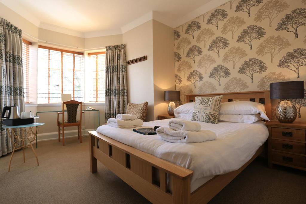 a bedroom with two beds with towels on them at B+B York in York