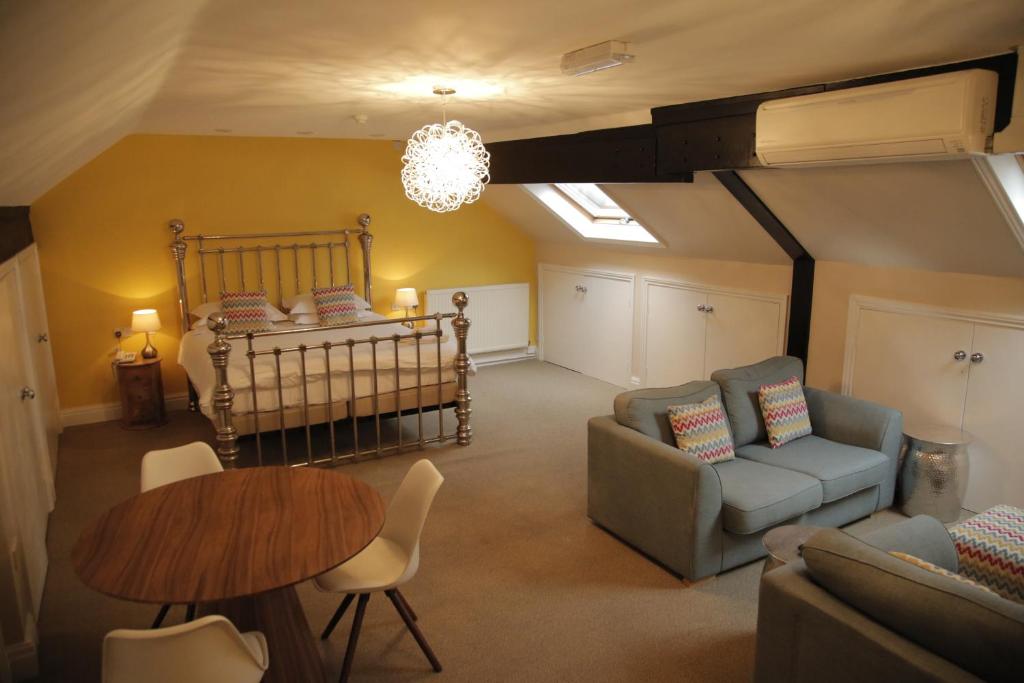 a living room with a bed and a table and chairs at B+B York in York