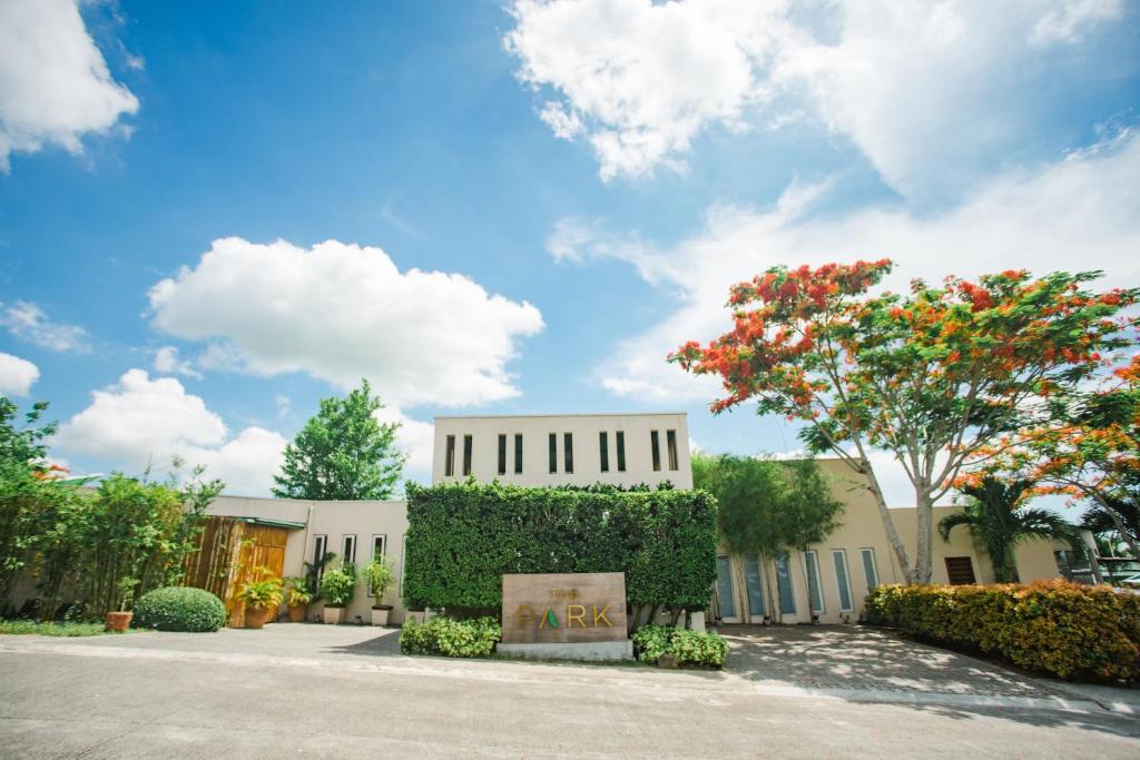 a white building with a tree in front of it at The Park - Silang in Silang