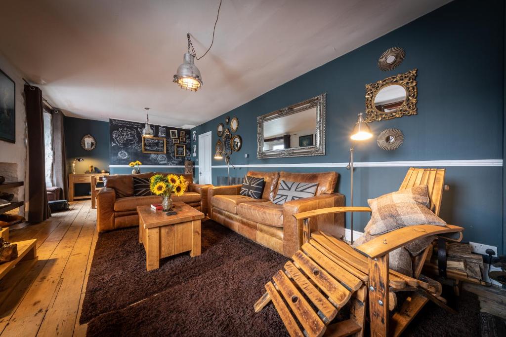 a living room with a couch and a table at Quayside Apartment in Portree