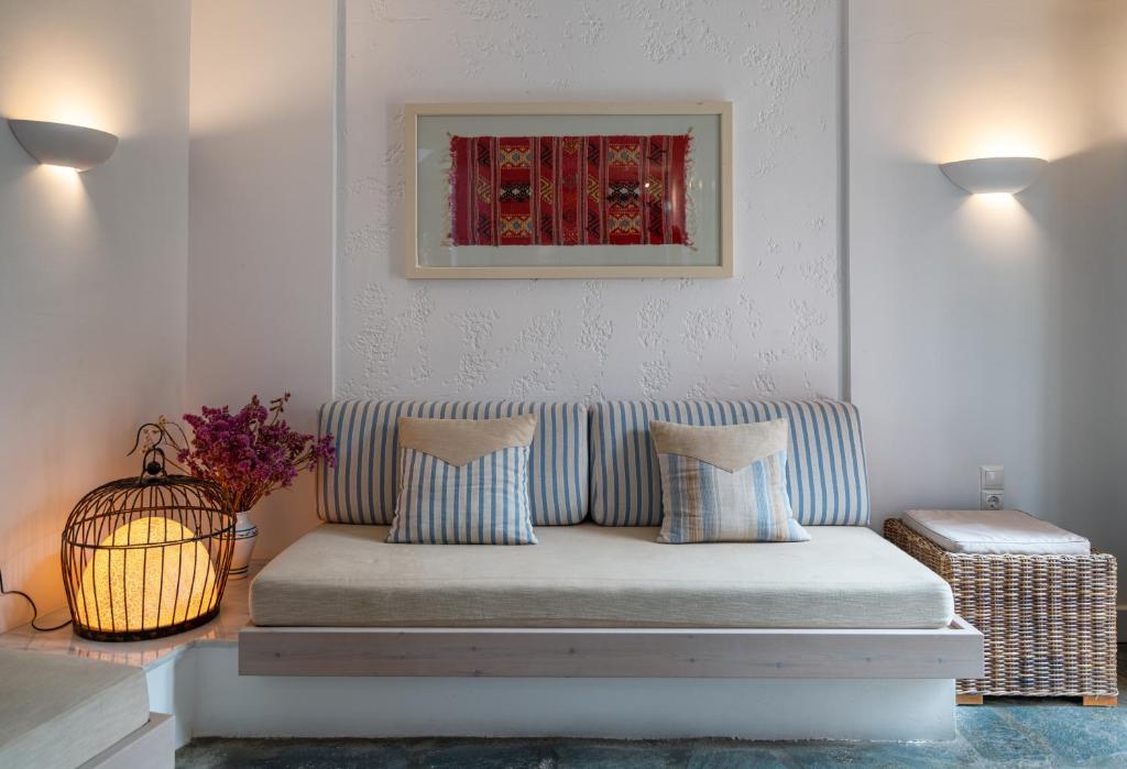 a couch in a living room with a picture on the wall at Koutouloufari Village Holiday Club in Hersonissos
