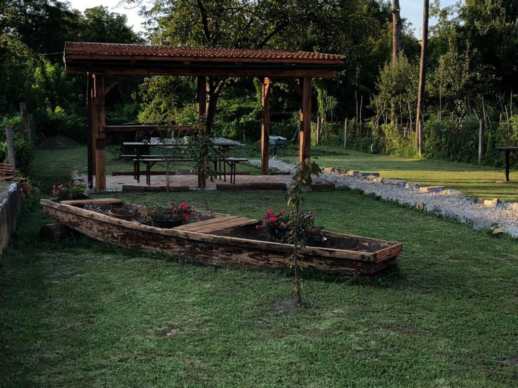 a garden with a wooden gazebo in the grass at Apartman Kupa in Karlovac