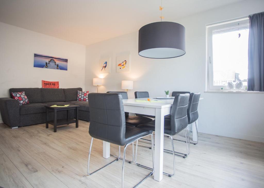a living room with a white table and chairs at Appartement Brink Am Waltenberg 57-59 in Winterberg