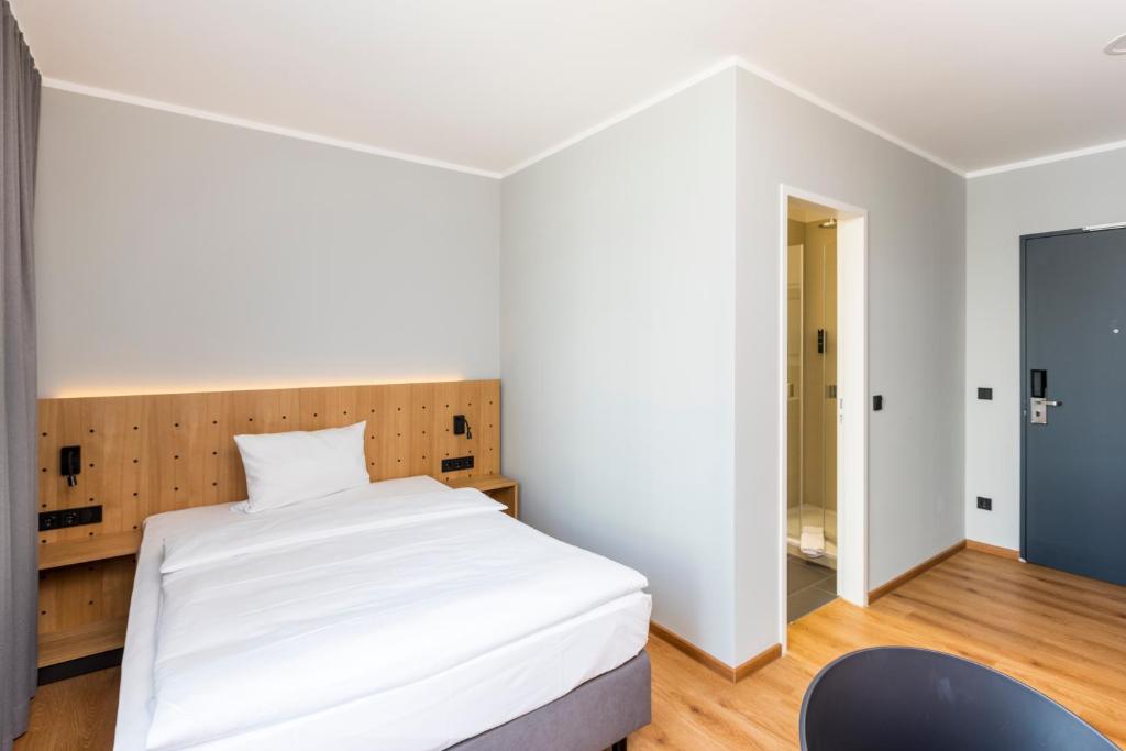 Postel nebo postele na pokoji v ubytování mk hotel eschborn