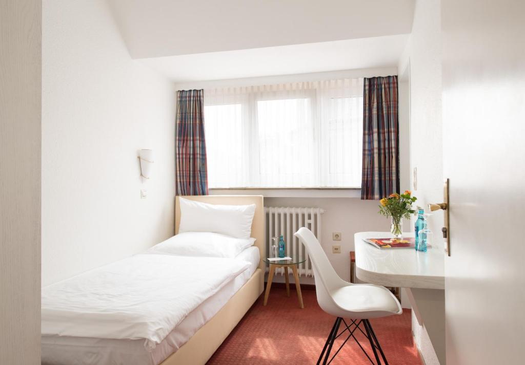 Postel nebo postele na pokoji v ubytování Hotel Feldmann