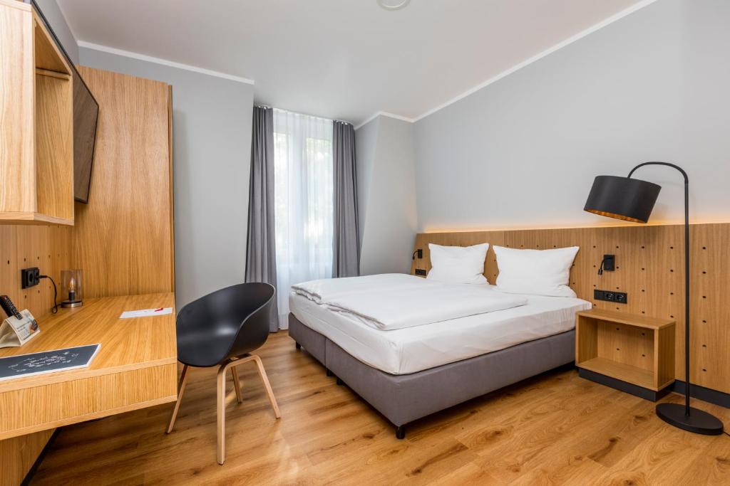 Postel nebo postele na pokoji v ubytování mk hotel eschborn