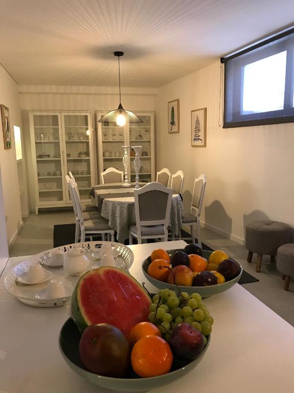 two bowls of fruit on a table in a dining room at House 41 in Vila Nova de Famalicão