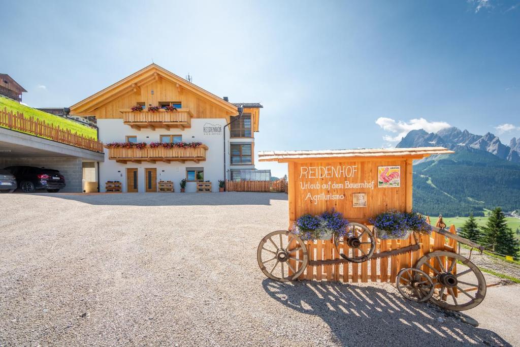 a building with a horse drawn carriage in front of it at Reidenhof in Sesto