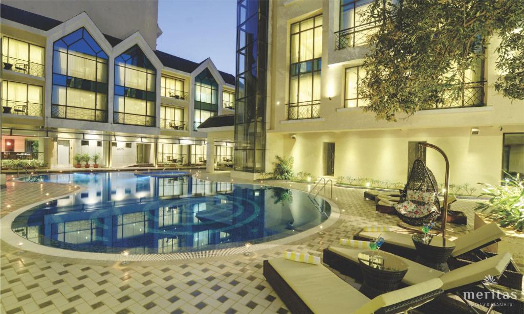 a large swimming pool in the middle of a building at Meritas Picaddle Resort Lonavala in Lonavala