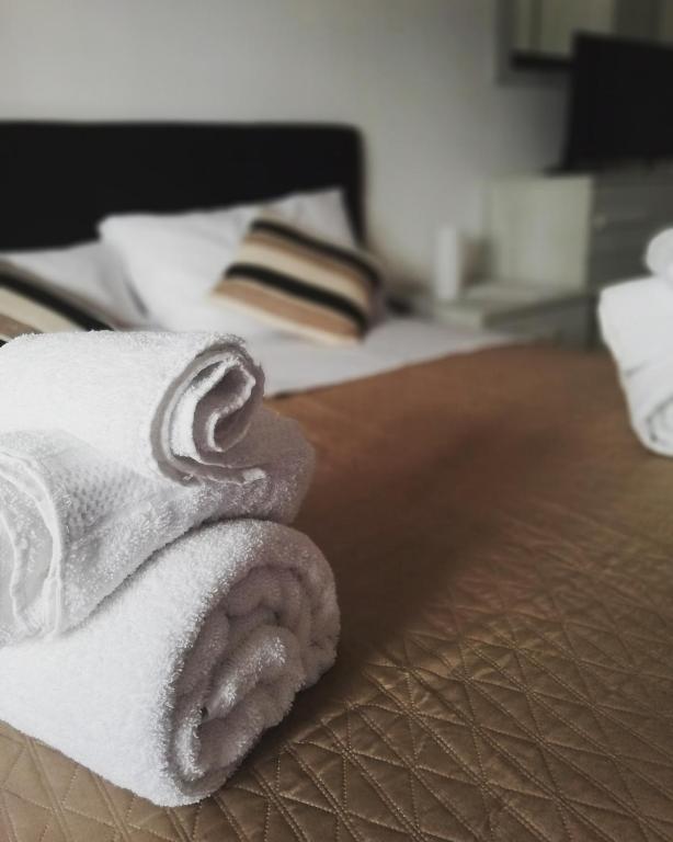 a pile of white towels sitting on a bed at Rosita Rooms in Lecce