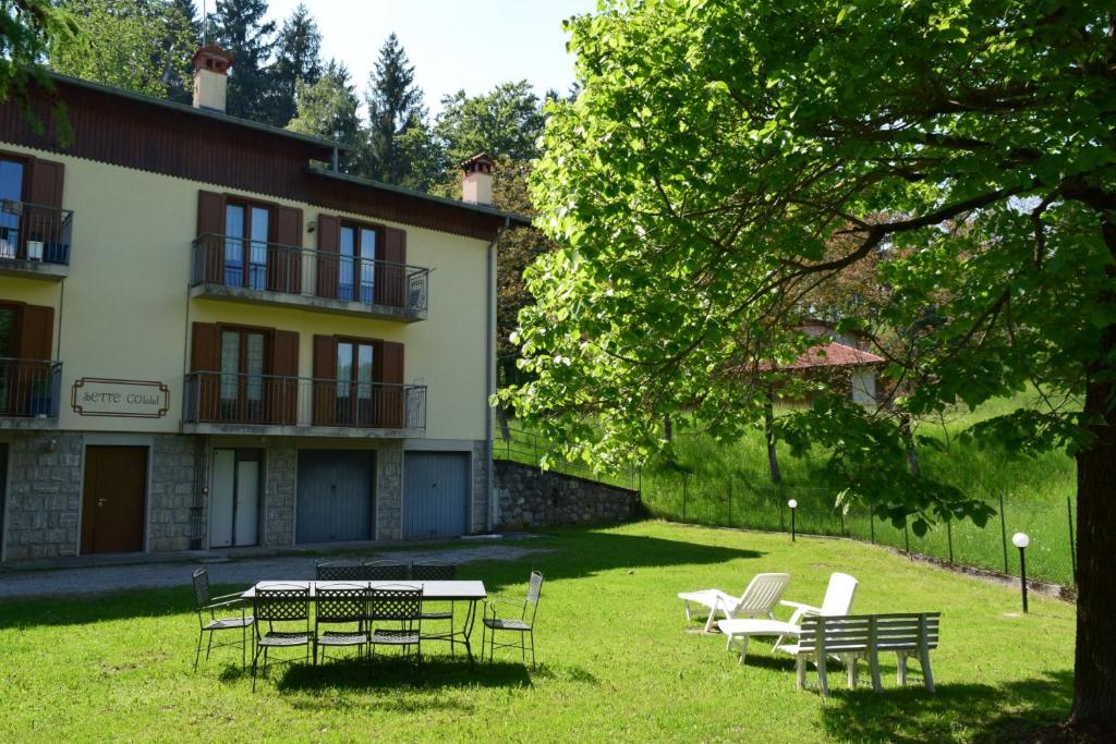 a group of chairs and tables in front of a building at Green House Mountain Lake Iseo Hospitality in Bossico