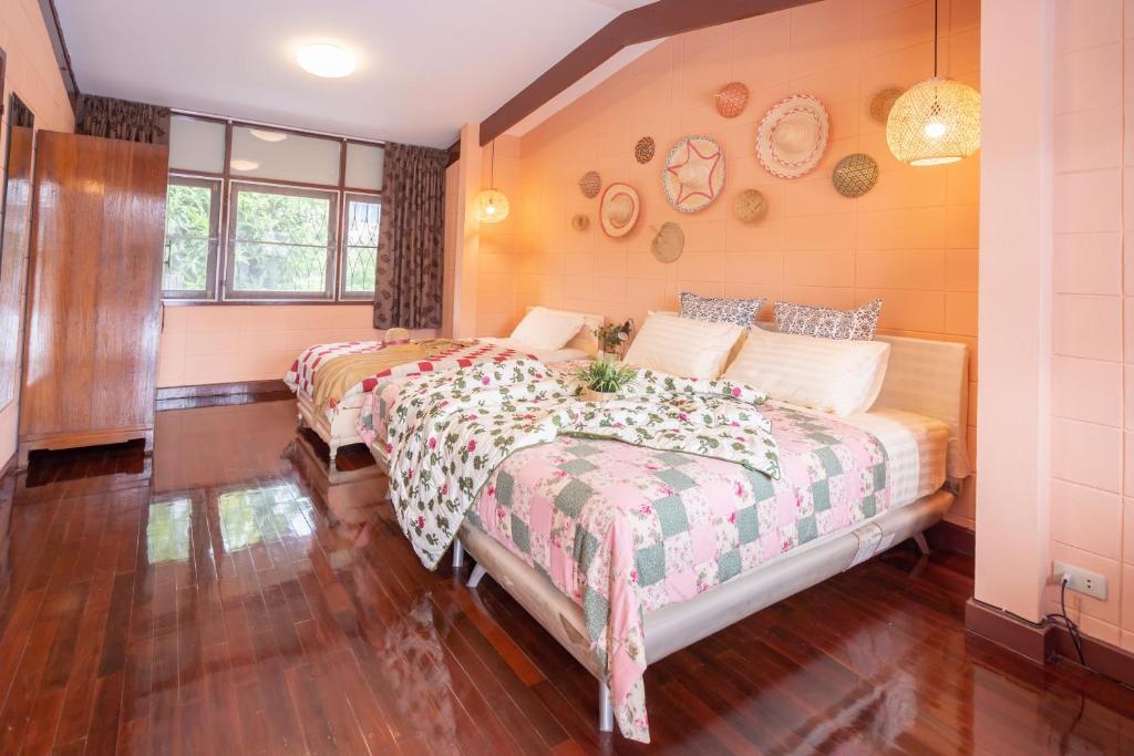 a bedroom with two beds in a room at Dunah's Garden Home in Bangkok
