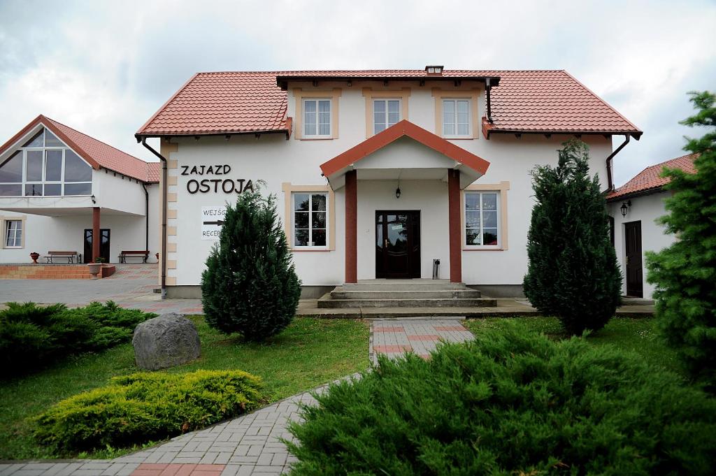 a white house with a red roof at Zajazd Ostoja in Stary Dzierzgoń