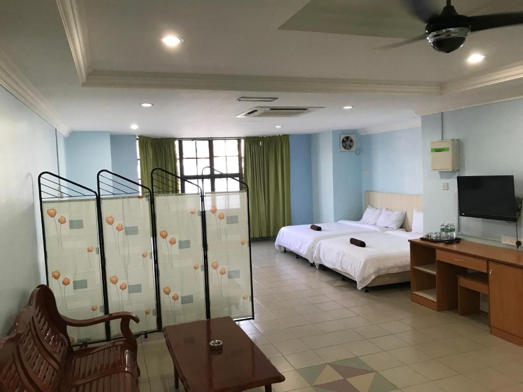 Postel nebo postele na pokoji v ubytování Hotel dan Restoran Seri Kangsar