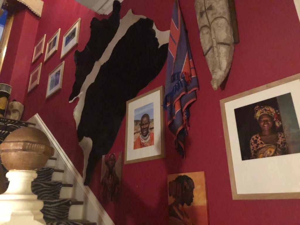 a wall with portraits and pictures on it at Belmont House Boutique - the Kingsley collection in Berwick-Upon-Tweed