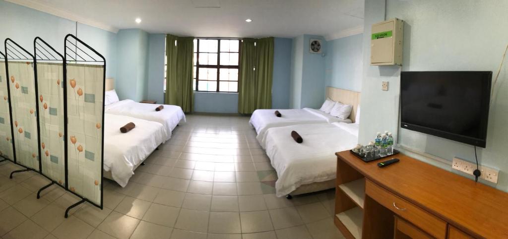 Postel nebo postele na pokoji v ubytování Hotel dan Restoran Seri Kangsar