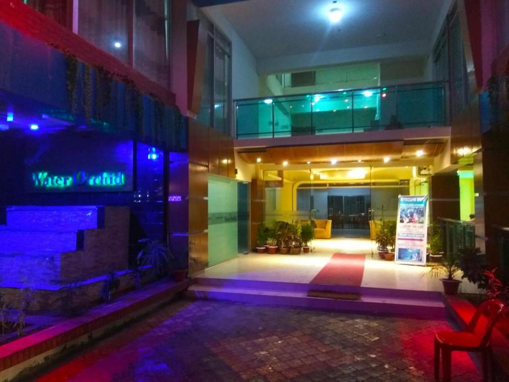 a lobby of a building with purple and green lights at Hotel Water Orchid in Cox's Bazar