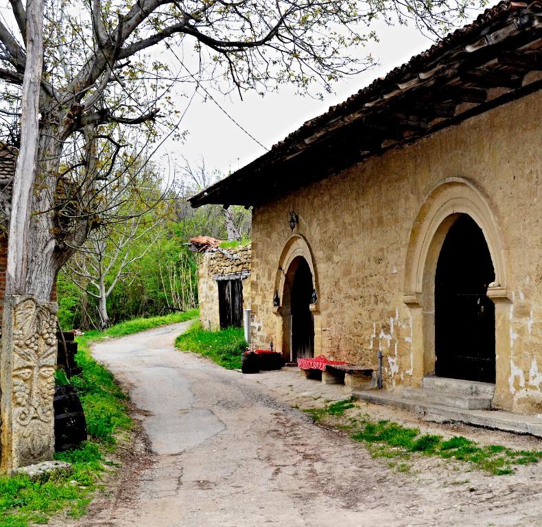 an old stone building with a path next to it at "Pivnica i smestaj Jovanovic"- Rogljevacke pivnice in Rogljevo