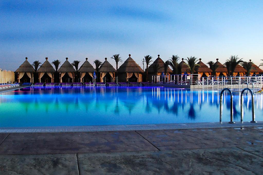 a large swimming pool with a resort in the background at Kengur Resort in Belgrade
