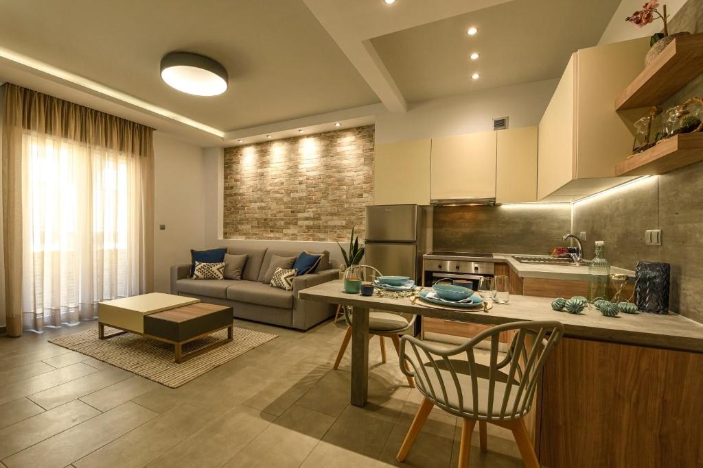 a kitchen and living room with a couch and a table at Sunny Luxury Suite Stone in Kavála