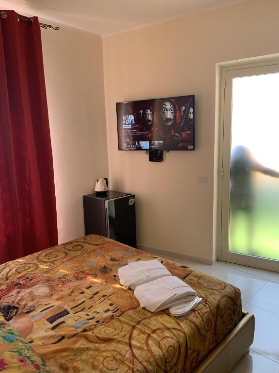 Posteľ alebo postele v izbe v ubytovaní National Gallery Taormina B&B