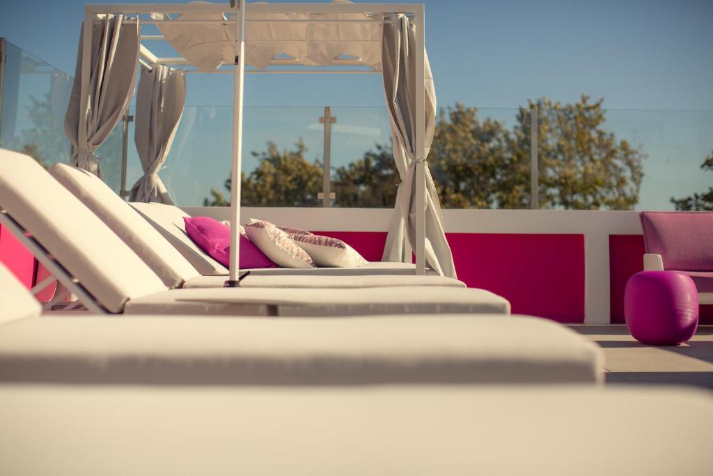 a row of beds with pillows on top of avisor at Chic Studios in Parede