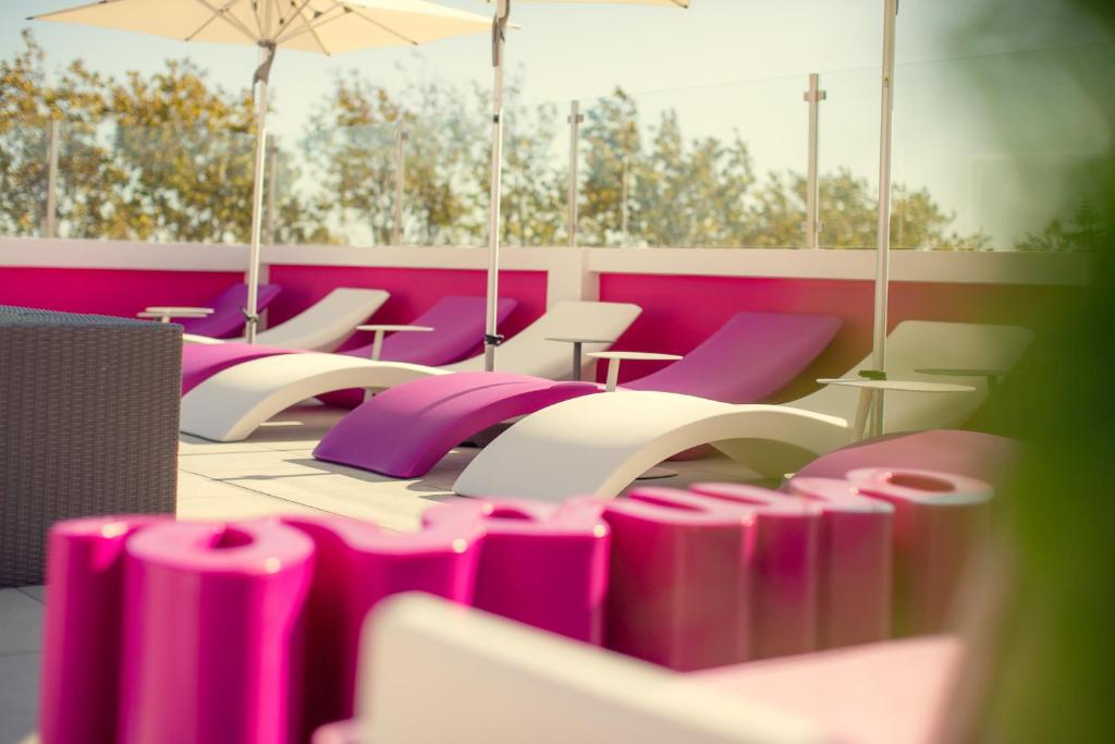 a row of purple and white chairs in a room at Chic Studios in Parede