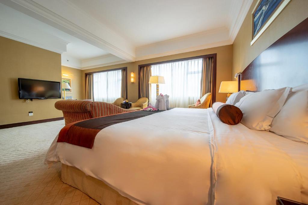 Postel nebo postele na pokoji v ubytování Grand International Hotel