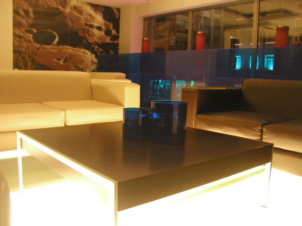 a coffee table in a room with couches and chairs at Hotel Moon in A Coruña