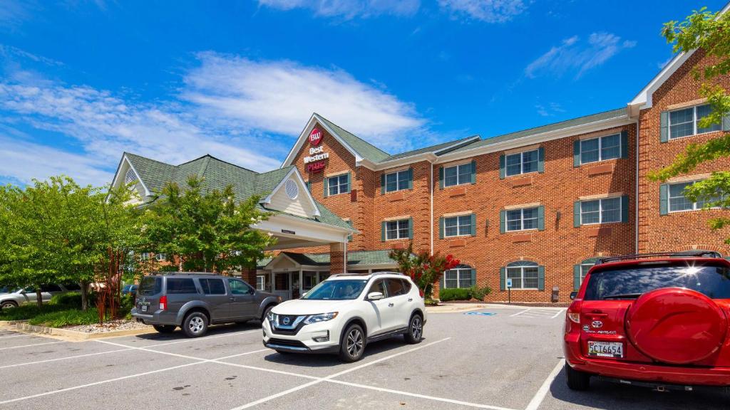 dos autos estacionados en un estacionamiento frente a un edificio en Best Western Plus Easton Inn & Suites, en Easton