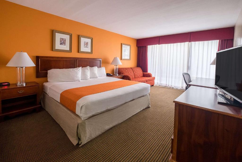 a hotel room with a bed and a television at Howard Johnson by Wyndham Fullerton/Anaheim Conference Cntr in Fullerton