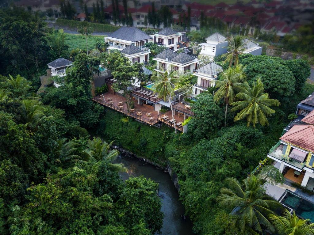 an aerial view of a house with a river at Annupuri Villas Bali in Canggu