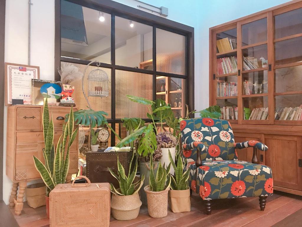 a living room with a chair and potted plants at Little B&B in Taitung City