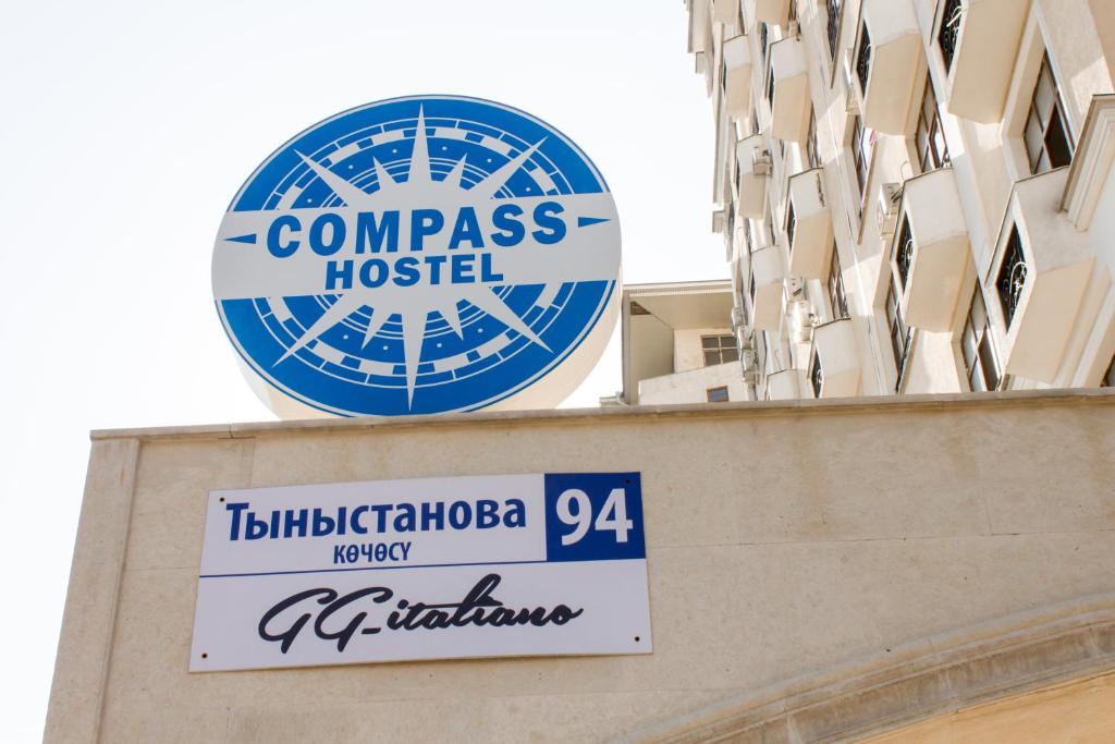 a sign on the side of a building with a hospital at Compass Hostel in Bishkek