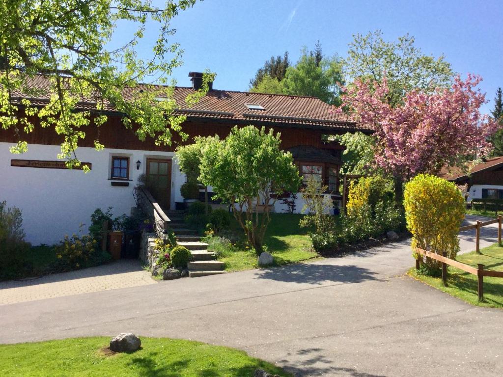 uma casa branca com uma cerca à frente. em Ferienwohnung Doris Strodl em Füssen
