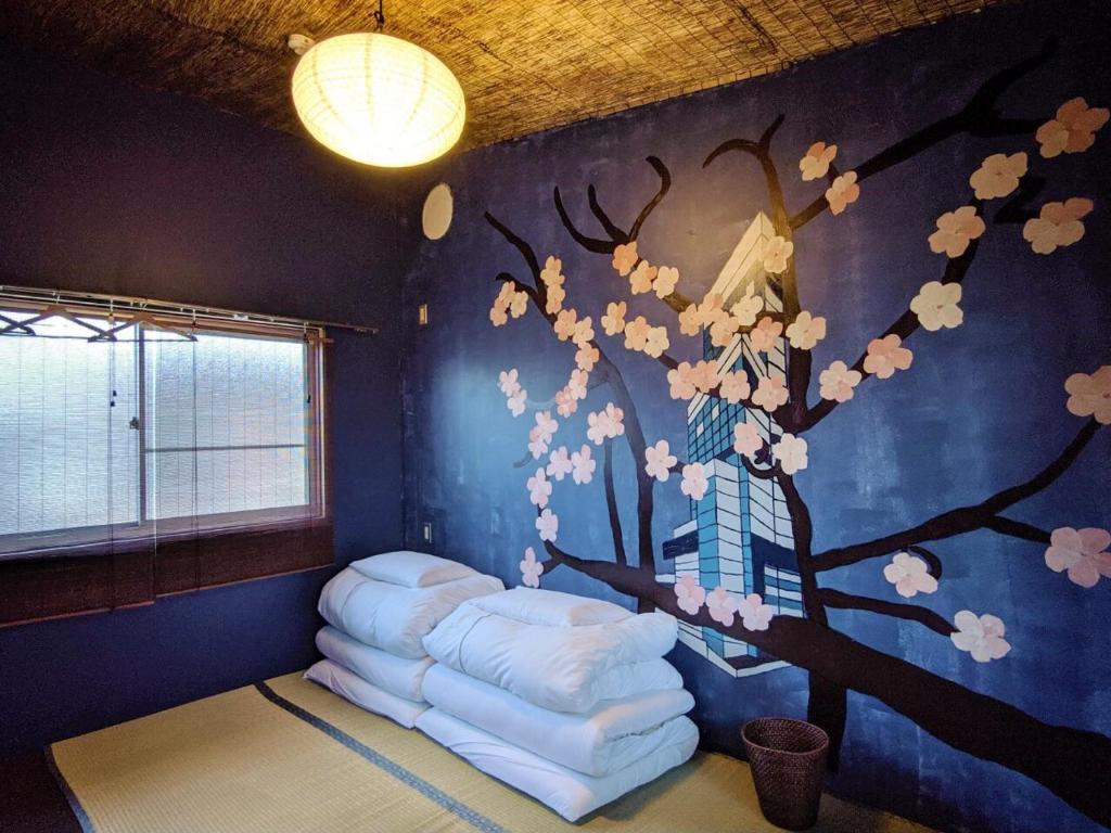 Postel nebo postele na pokoji v ubytování Mad Cat Hostel Osaka & Bar
