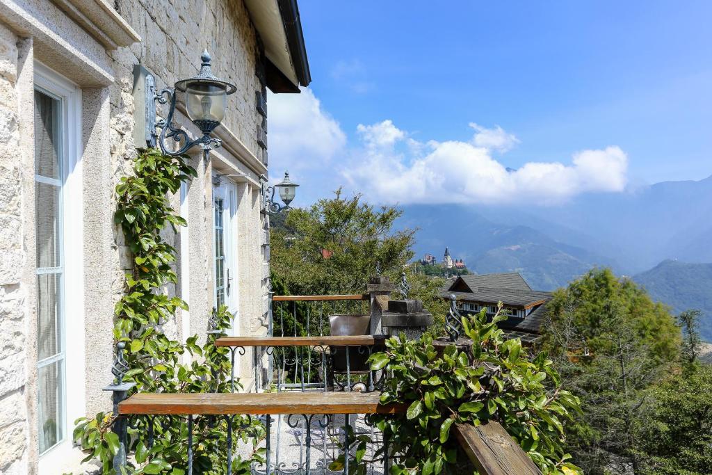 a balcony of a building with a view of the mountains at Shangrila Music Villa in Ren&#39;ai