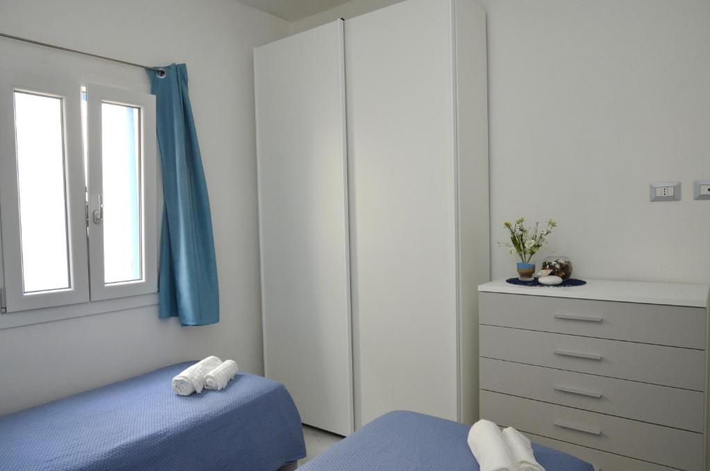 Postel nebo postele na pokoji v ubytování A Due Passi Dal Mare
