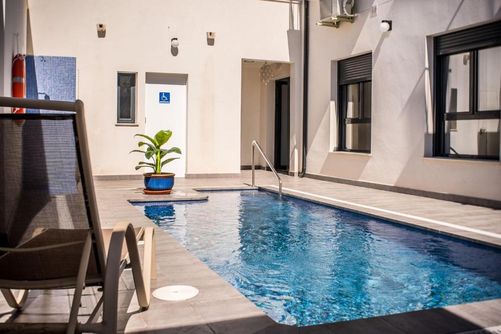 a swimming pool in the middle of a building at Apartamentos La Laguna in Fuente de Piedra