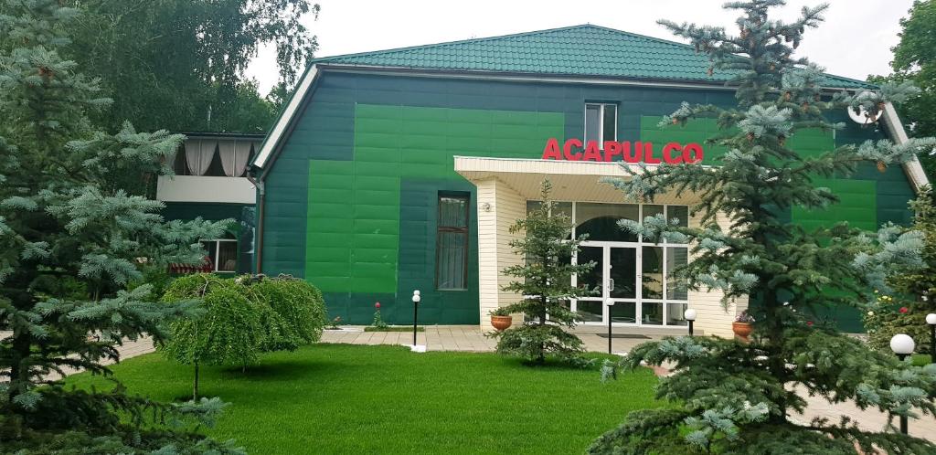 Pivdenne的住宿－ACAPULCO，绿色建筑,上面有红色标志