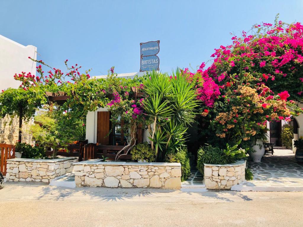 a building filled with lots of plants and flowers at Batistas Apartments in Naousa