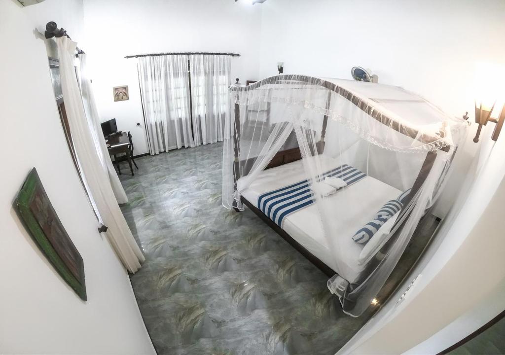 Postel nebo postele na pokoji v ubytování Araliya Gardens Hotel