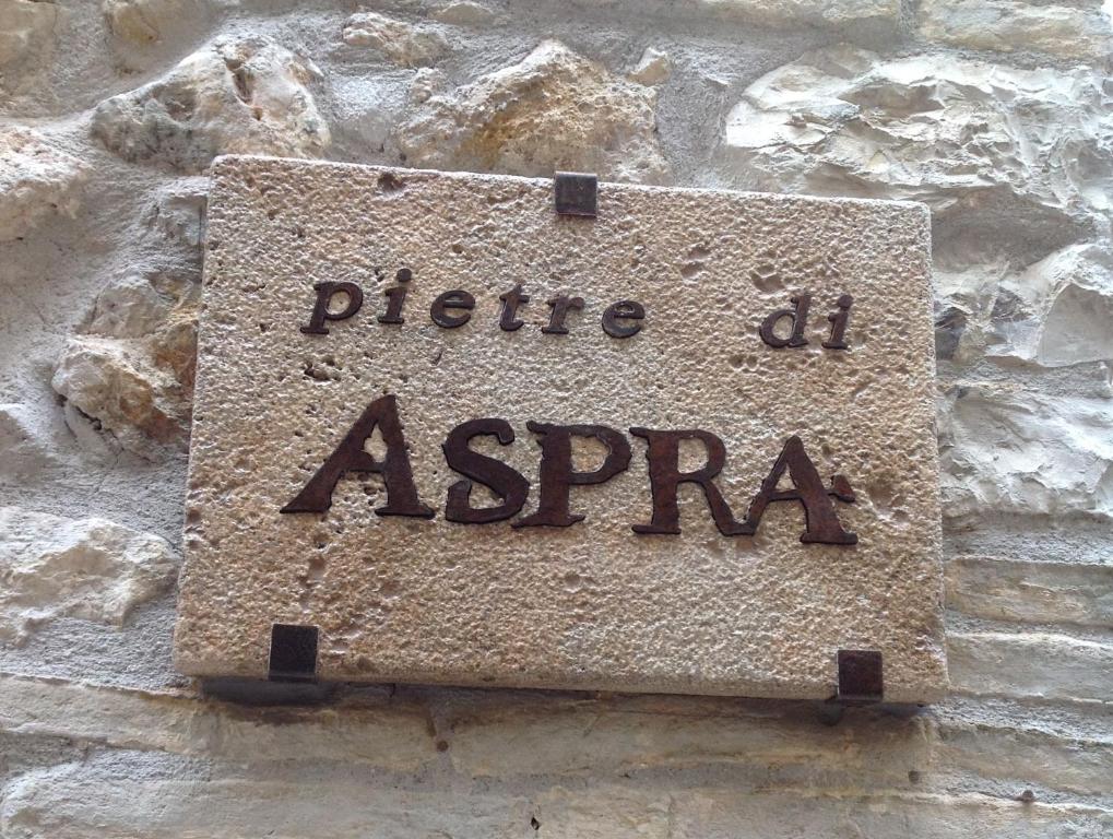 una señal de piedra en el lateral de una pared de piedra en pietre di ASPRA, en Casperia