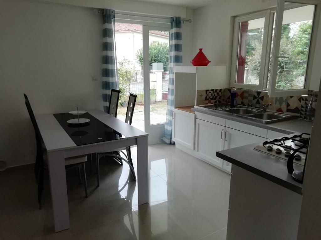 a kitchen with a table and chairs in a room at Chez Laurent in Bergerac